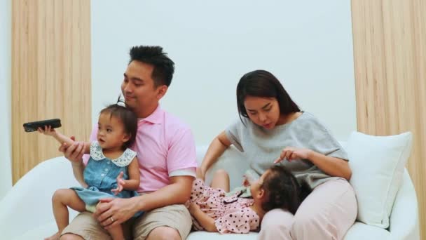 Happy Asian Family Parents Sit Look Petulant Little Daughter Sofa — Stock Video