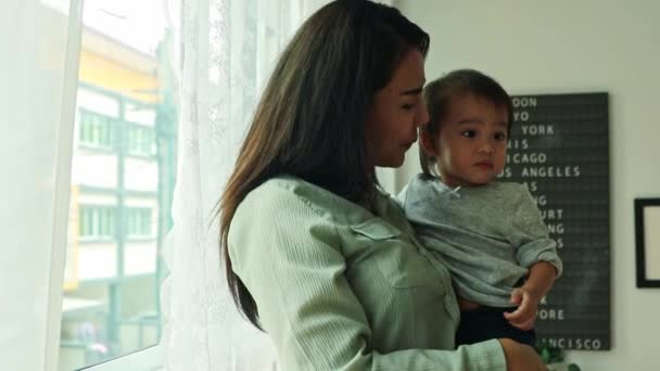 Portrait Mother Holding Cute Daughter Standing Bedroom Window — Stok Video