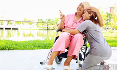 Kanserli neşeli yaşlı anne başörtüsü takıyor. Bebek arabasıyla gökyüzüne bakıyor. Sevgi ve sevgiyle sarılıyor..