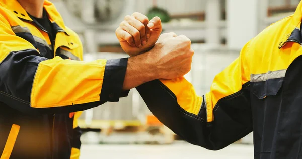Cropped photos show positive feelings and strength to fight against work : Engineering colleagues bump fist positive energy together show professionalism engineer industrial work successful team.