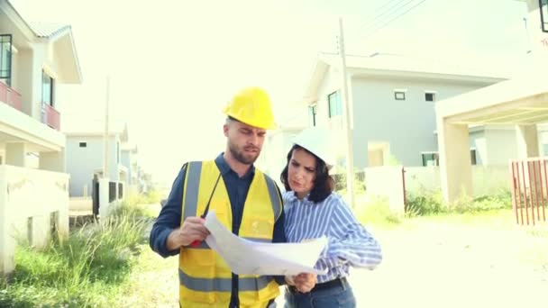 Male Foreman Stands Holding Blueprint House Plan Consults Female Project — Stock Video