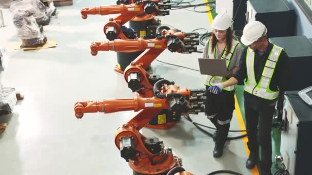 Top View Male Female Expert Engineers Inspecting All Robots Awaiting — Stock Video