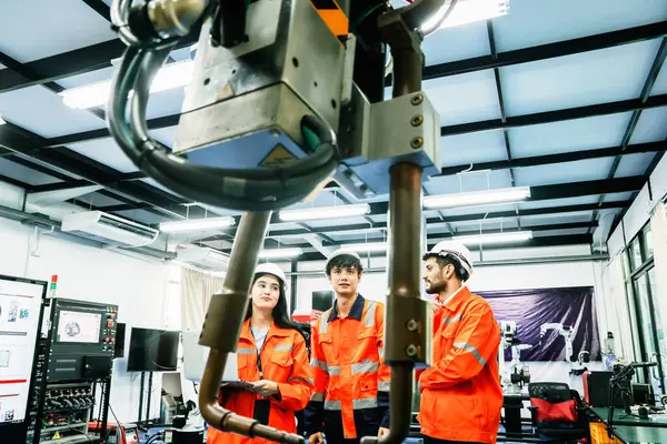 Team male and female robot engineering students at the robot development Institute studies and researches the operation robot arms support modern industries that use remote controlled robot machinery.