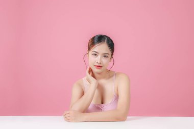 Çekici yüzlü güzel Asyalı kadın dikkat çekiyor. Sağlığınıza dikkat edin ve cildinize dikkat edin ve yumuşakça barışın büyüleyici Taylandlı kız gülümser ve kameraya bakar..