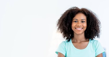 Portrait images of and African American girl, she has curly black hair and a beautiful smile, on white background. to people and black skin concept.