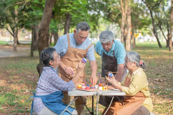 Asian elderly group Do activities together in the park Coloring ceramic pottery Creative ideas in retirement