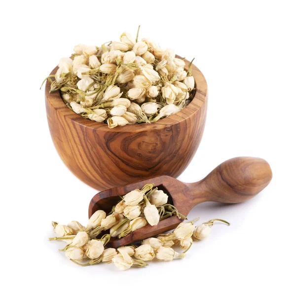 stock image Dry jasmine flowers in wooden bowl and spoon, isolated on white background. Jasmine flowers tea. Herbal tea