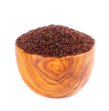 Psyllium seeds in wooden bowl, isolated on white background. Plantain. Plantago psyllium