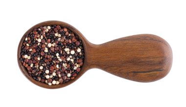 Quinoa seeds in wooden spoon, isolated on white background. Mix of white, red and black quinoa. Top view