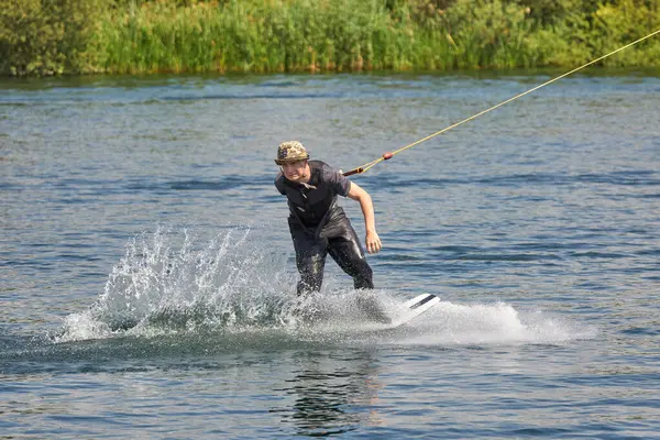 stock image Man performing a jump trick on a wake board      