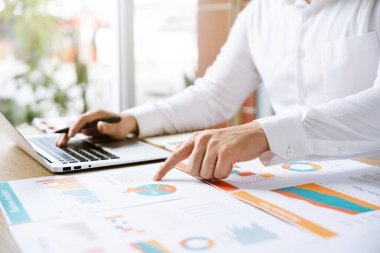 Businessman analyzing company growth, future business growth arrow graph, development to achieve goals, business outlook, financial data for long term investment.