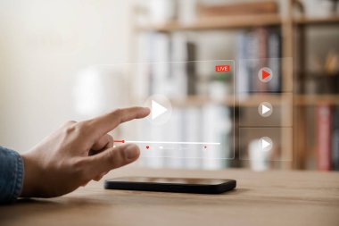 Akıllı telefonlu çevrimiçi film yayını. Genç adam cep telefonundan hayali bir video oynatıcı servisi ile film izliyor..