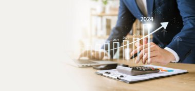 businessman new year business goals 2024, positive indicators 2024, positive indicators 2024, company competitiveness on global scale, businessman calculating financial data for long term investments.