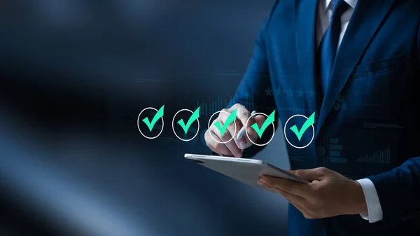 Business performance monitoring concept, businessman using tablet Online survey filling out, digital form checklist, blue background.