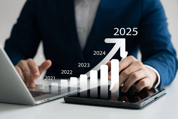 businessman new year business goals 2025, positive indicators 2025, company competitiveness on global scale, businessman calculating financial data for long term investments.