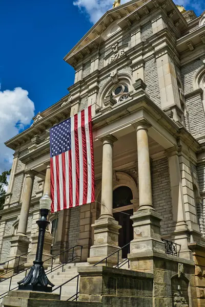 stock image USA Flag in front of the Licking County courthouse in Newark Ohio USA 2024