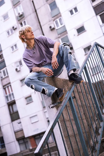 Teenage Boy Sitting Urban Exterior Surrounded Buildings — Fotografia de Stock