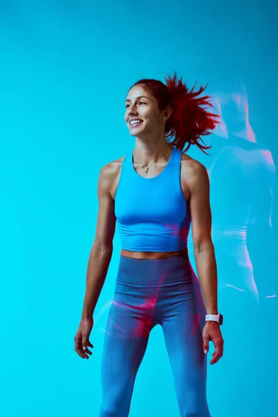 Happy Sportswoman Exercising Studio Isolated Blue Background Long Exposure Capture — Stock Photo, Image