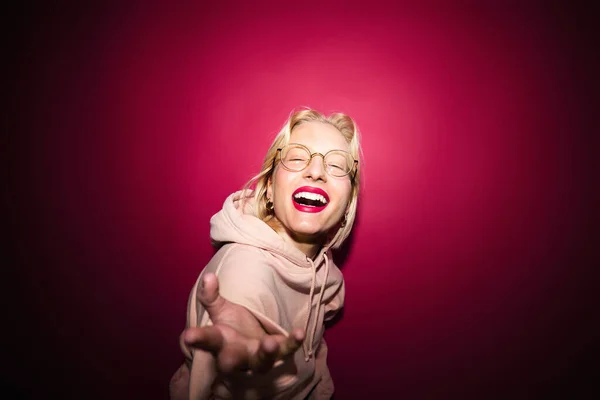 Playful Young Blond Woman Posing Isolated Magenta Background While Laughing — Fotografia de Stock