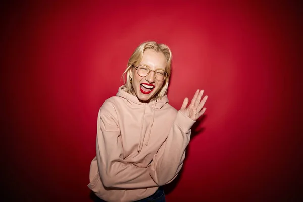 Happy Blond Woman Posing Studio Isolated Red Background Laughing Camera — Fotografia de Stock