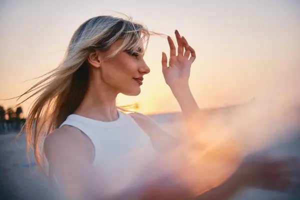 Backlit Blonde Woman Adjusts Her Hair Beach Beautiful Gradient Sunset Stock Image