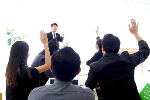 Business discussing at conference office desk, businesspeople raising hand up to ask question at group board meeting during presentation, successful company teamwork meeting, raise hand at seminar.