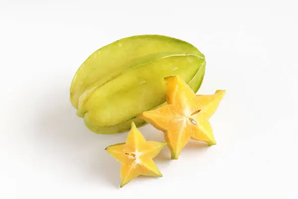 stock image Two ripe juicy carambola starfruit whole with slice on white background. Averrhoa carambola, star apple, delicious tropical fruit.