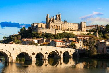 Old bridge over the Orb river and Saint Nazaire cathedral in Beziers, Herault, Occitanie, France clipart