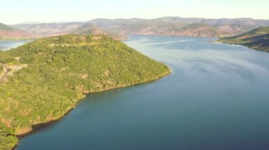 Flying over Lake of Salagou, on a calm summer morning, in Herault, Occitanie, France