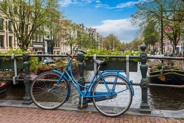 Bicycle on a bridge spanning a canal in Amsterdam in Holland in the Netherlands