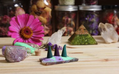 Incense Cones on Stone Slab With Chakra Crystals and Flowers