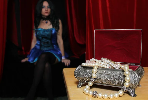 Vintage Jewelry Box with Pearls, Woman wearing Blue corset in background