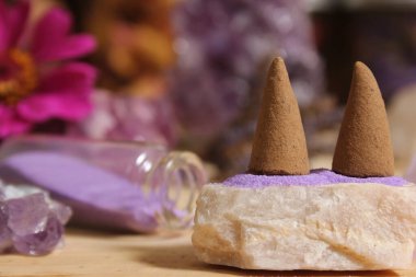 Amethyst Crystals With Flowers and Incense Cones on Meditation Altar