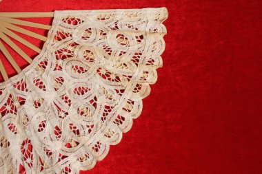 Vintage Cream Colored Lace Hand Fan On Red Velvet Background