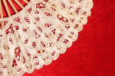 Vintage Cream Colored Lace Hand Fan On Red Velvet Background