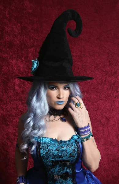 Woman Dressed Blue Witch Red Velvet Background — Stock fotografie