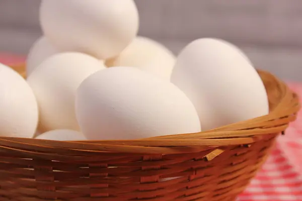 Basket of Farm Fresh Eggs on Red and White Checkered Table Cloth
