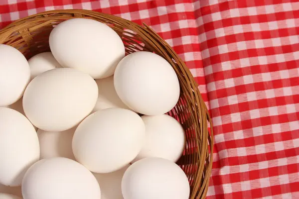 Basket of Farm Fresh Eggs on Red and White Checkered Table Cloth