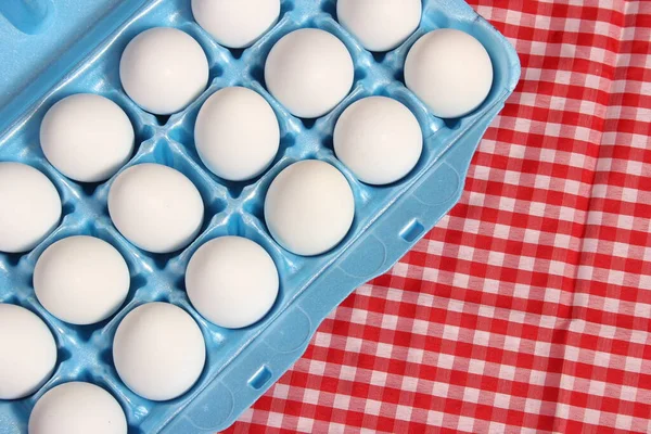 Carton of Eggs on Rustic Table With Red Checkered Table Cloth