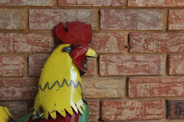 Metal Rooster on Brick Wall. Rural East Texas