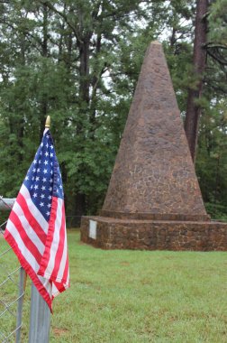 Killough Monument and Cemetery During Rain With American Flag Located Near Bullard Texas clipart