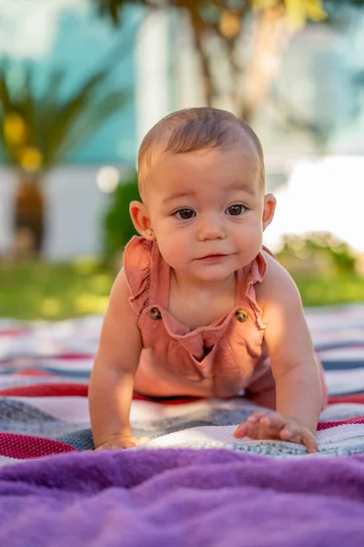 小さな笑顔の赤ちゃんは 家の庭のカラフルな毛布にクロールすることを学びます ベビーラーニングと開発コンセプト — ストック写真