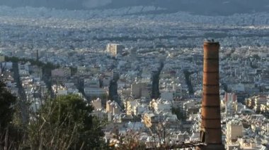Atina-Yunanistan kentindeki terk edilmiş bir kireç fırını fabrikasının zaman aşımına uğramış görüntülerini büyüt. Bulutlar bacanın arkasından geçiyor. .