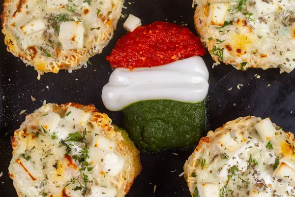 Dört peynirli sarımsaklı ekmek arasında portakal, beyaz ve yeşil sos veya chatani. tiranga kavramı.