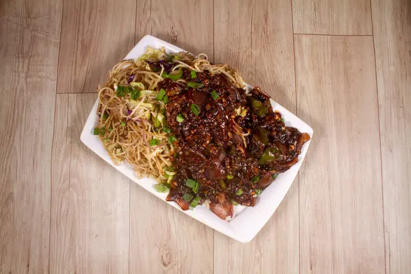 stock image mix veg noodles with oriental sauce and vegetables carrot, bell pepper and green beans in plate on wooden background.