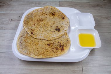 Puran Poli, also known as Holige, is an Indian sweet flatbread from India consumed mostly during Holi festival. Served in a plate with pure Ghee. clipart