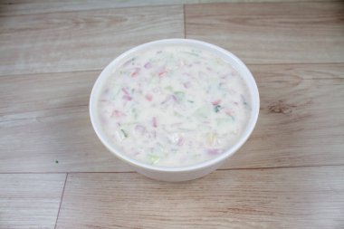 Onion Raita pyaj or kanda Koshimbir Indian salad is a condiment from the Indian subcontinent, made with dahi or curd together with raw or cooked vegetables clipart