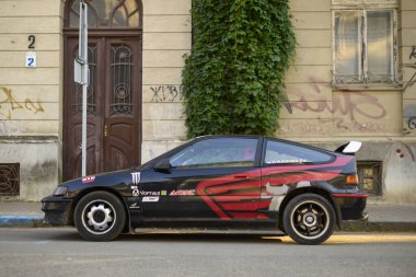 Ivano-Frankivsk, Ukraine - 19 June 2024: black Honda CRX sport compact liftback car rear side view. Style of 80s, 90s. clipart