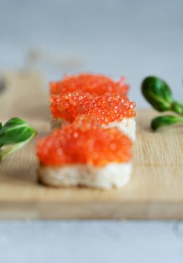 red caviar canapes in the shape of the heart, tasty healthy food. High quality photo
