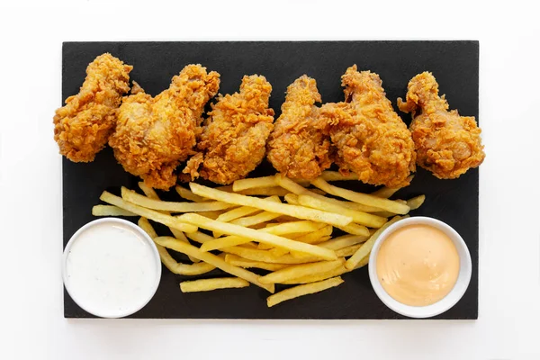 Mega Tasty crispy chicken wings with fries and 2 sauces. High quality photo